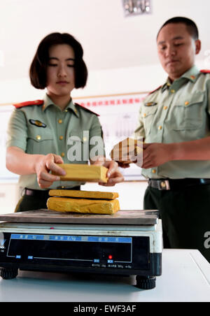(150625) -- DEHONG, June 25, 2015 (Xinhua) -- Zhang Liu (L) and her comrade prepare to weigh drugs they captured at border checkpoint of Mukang in Dehong Dai-Jingpo Autonomous Prefecture, southwest China's Yunnan Province, June 24, 2015. Born in 1995, Zhang Liu became an anti-drug soldier in border checkpoint of Mukang in 2013. Grown up in an affluent family in central China's Hunan Province, Zhang said that being a soldier had always been her dream, which drove her to join the army after graduating from high school. Being a front line anti-drug force, the border checkpoint of Mukang has capt Stock Photo