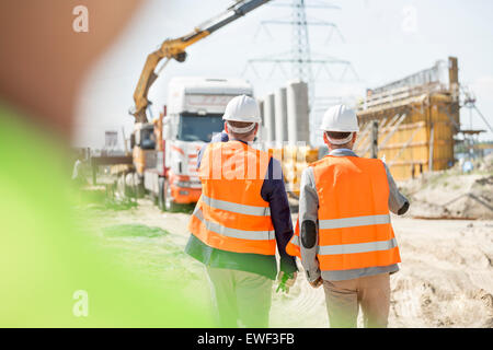 Rear view of supervisors walking at construction site Stock Photo