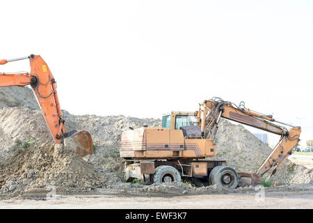 Bulldozers on construction site against clear sky Stock Photo
