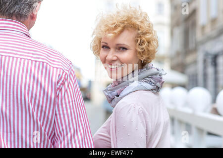 Portrait of happy middle-aged woman with man outdoors Stock Photo