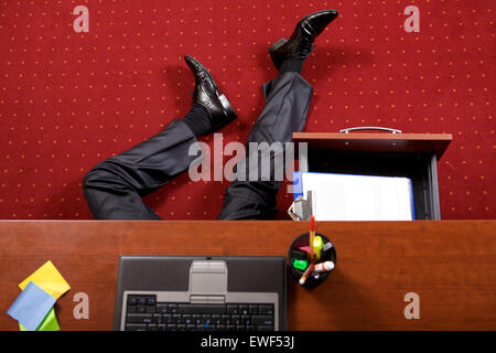 Businessman lying in the office Stock Photo