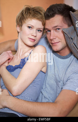 Attractive young couple resting while sitting at the tent outdoors