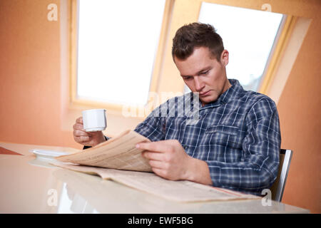 Man reading newspaper Stock Photo