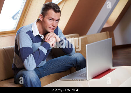 Man sitting on sofa Stock Photo