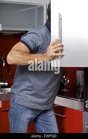 Young man looking in refrigerator Stock Photo