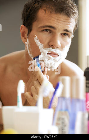 Young man shaving Stock Photo