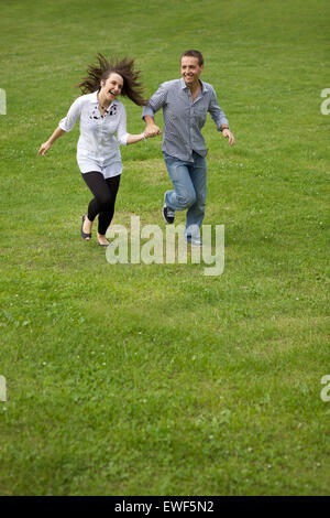 Young couple running in park Stock Photo