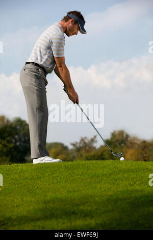 Young man playing golf Stock Photo