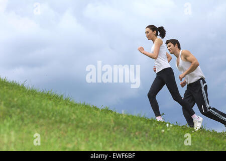 Young couple exercising in park Stock Photo