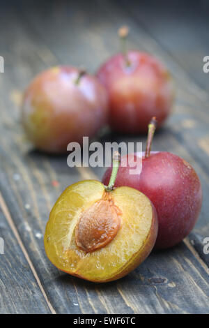 Plums on wooden table - close-up Stock Photo