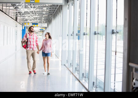 Full-length of couple walking in covered passage Stock Photo