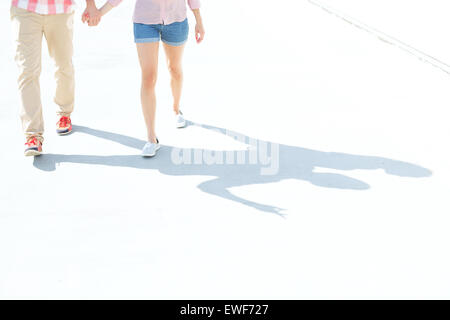 Low section of couple walking on street Stock Photo
