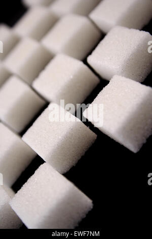 Lump sugar on black background Stock Photo