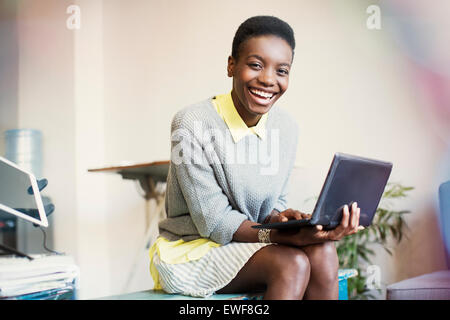 Portrait smiling businesswoman working with digital tablet Stock Photo