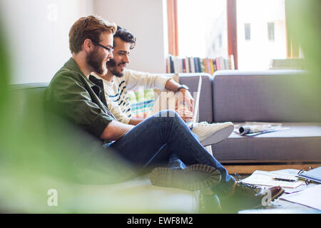 Casual businessmen using laptop on sofa Stock Photo