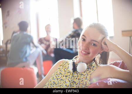 Portrait smiling casual businesswoman with headphones Stock Photo