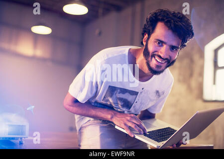 Portrait enthusiastic casual businessman with laptop in office Stock Photo