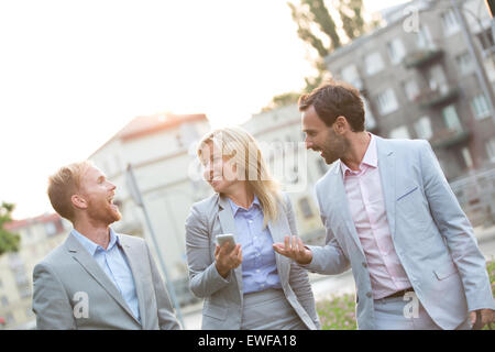 Cheerful businesspeople walking in city Stock Photo