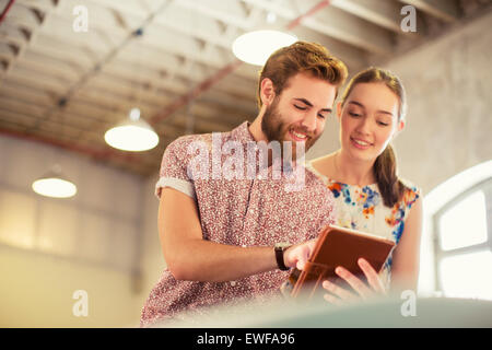 Casual business people sharing digital tablet in office Stock Photo