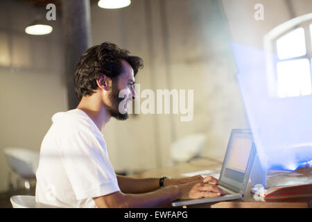 Casual businessman working at laptop in conference room Stock Photo