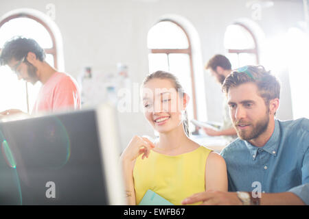 Casual business people using computer in office Stock Photo