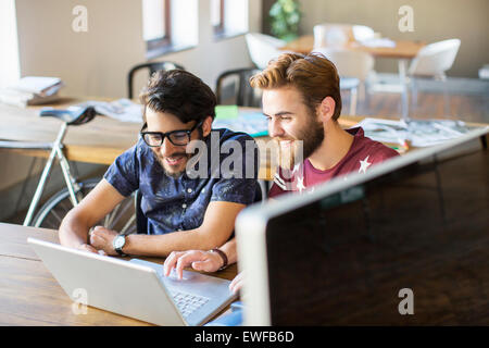 Casual businessmen working at laptop in office Stock Photo
