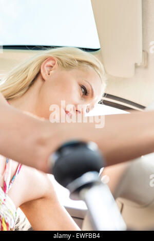 Low angle view of woman sitting in car Stock Photo