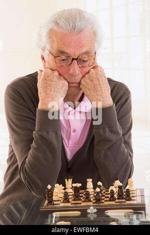 SENIOR PLAYING CHESS Stock Photo