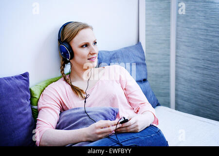 WOMAN LISTENING TO MUSIC Stock Photo