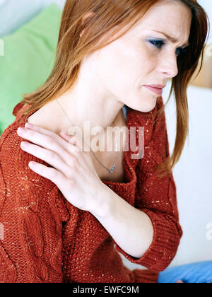 WOMAN WITH SHOULDER PAIN Stock Photo