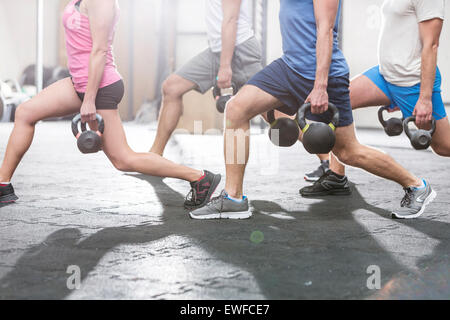 Low section of people lifting kettlebells at crossfit gym Stock Photo
