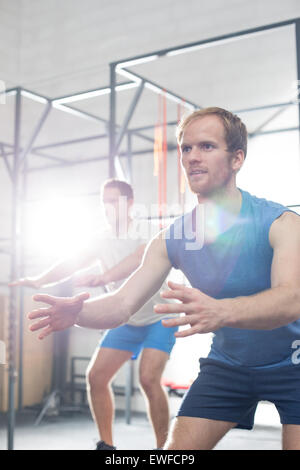 Determined men exercising at crossfit gym Stock Photo