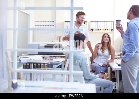 Architects talking and drinking coffee in office Stock Photo