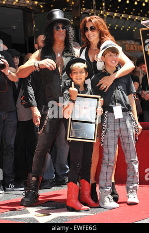 LOS ANGELES, CA - JULY 10, 2012: Rock guitarist Slash & sons & wife Perla Ferrar on Hollywood Blvd where he was honored with a star on the Hollywood Walk of Fame. Stock Photo