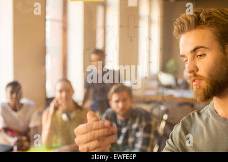 Casual businessman explaining diagram on glass in meeting Stock Photo