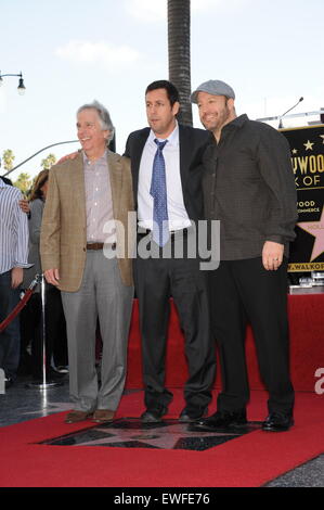 LOS ANGELES, CA - FEBRUARY 1, 2011: Adam Sandler with Henry Winkler & Kevin James (right) on Hollywood Boulevard where Sandler was honored with the 2,431st star on the Hollywood Walk of Fame. Stock Photo