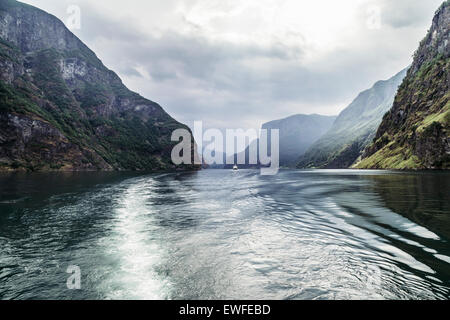 Sognefjord, near the point where Aurlandsfjord meets Naeroyfjord, Norway, with tourist ferry boat in distance Stock Photo