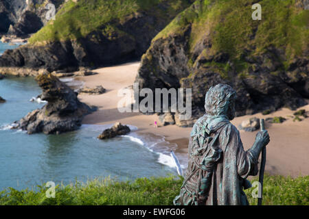 Llangrannog village, statue of St Carannog, beach and cliffs on the Wales Coast path, Ceredigion. Stock Photo