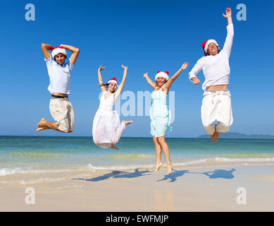 Two couple celebrating on the beach on Christmas. Stock Photo