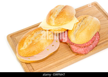 German bread rolls with mortadella, cheese and pepper cervelat on a wooden breakfast tray Stock Photo