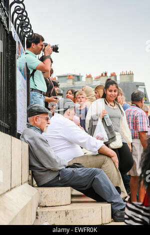 Paris, France - August 9, 2014: Crowd of tourists are on the stairs near Sacre Coeur Basilica in summer day Stock Photo