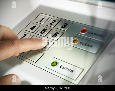 Finger about to press a pin code on a pad. Security code on an Automated Teller Machine, ATM Stock Photo