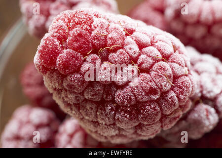 Extreme macro shot of a frozen raspberry covered with ice crystals Stock Photo