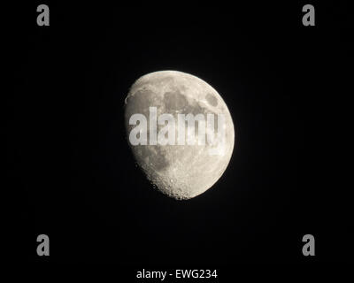 A clear view of the Waxing Gibbous Moon, showing distinct craters on its surface. The dark background highlights the moon's details, providing a stunning celestial view for astronomy enthusiasts. Stock Photo