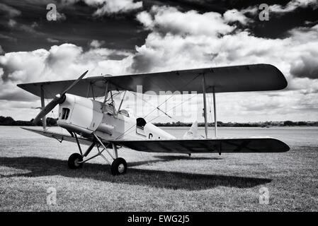 DH82A Tiger Moth Biplane at Bicester flywheel festival. Oxfordshire, England. Monochrome Stock Photo