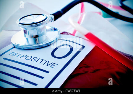 closeup of a blood bag with a label with the text O RH positive and a stethoscope Stock Photo