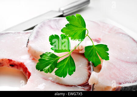 closeup of some slices of frozen blue shark on a white worktop Stock Photo