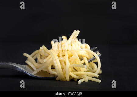 spaghetty rolled on fork in black background Stock Photo