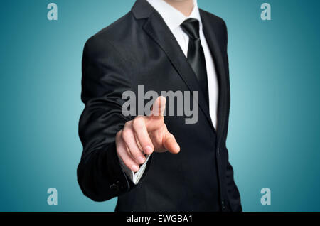 Business man pressing imaginary button Stock Photo