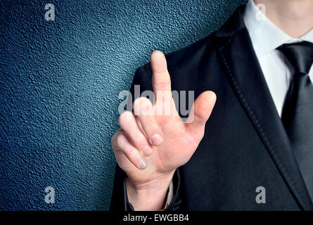 Business man pressing imaginary button Stock Photo